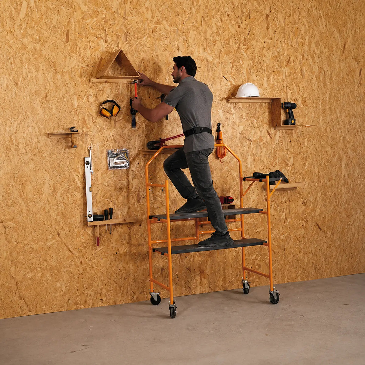 Worker using the Summit Tools 4ft Mini Scaffolding Set in a workshop