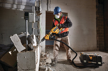 DeWalt DCH614X2 60V MAX Cordless Brushless SDS MAX 1-3/4 inch Combination Rotary Hammer Kit showing in use chipping and breaking down a concrete wall